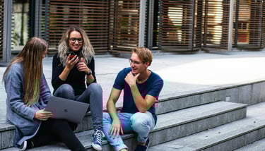 group of young millennials chatting in group on stairs representing gold ira for millennials