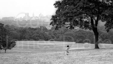 A child runs on Belmont Plateau in Philadelphia in the 1960s by James Drake