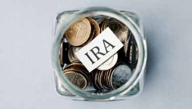 coins in a jar for an individual retirement account