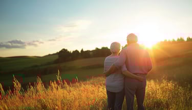 elderly couple watching the scenery and sunset with long term care insurance