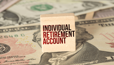individual retirement account label on a block with money in the background