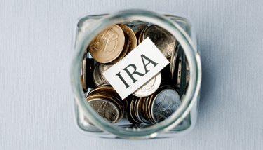 coins in a jar for an individual retirement account