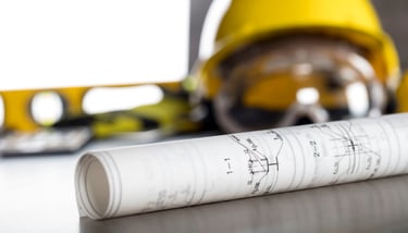 General contractor hard hat and floor plans.