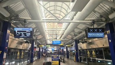 AirTrain terminal at JFK with route display showing train lines and destinations