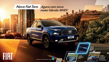 Blue Fiat Toro pickup truck with new MHEV hybrid engine driving through a modern city at sunset.