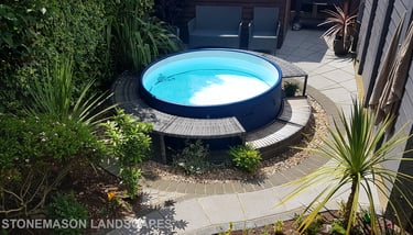 Small tropical garden with fanned paving slabs in circle around hot tub