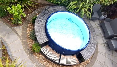 Small tropical garden with fanned paving slabs in circle around hot tub