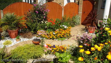 Curvey winding path, circle kits paving slabs weaving through lots of beautiful plants & flowers
