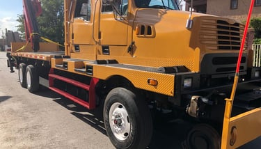 a yellow crane truck with a crane on it