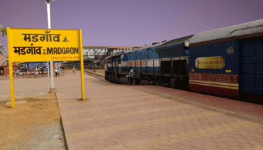 a margao railway station with a train on the tracks