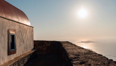 a building with a window and a window with a view of the ocean