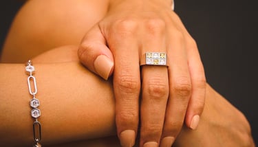 BONHEUR JEWELRY a silver gemstone ring and a diamond link bracelet.