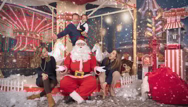 a man in a santa clause costume sitting on a carousel