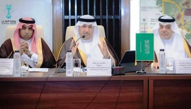 a group of men sitting at a table with microphones