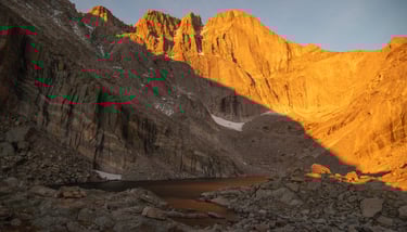 Longs Peak and chasm Lake glow brilliantly during summer sunrise