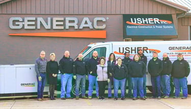 Usher's Ownwers and staff in front of there trucks and building