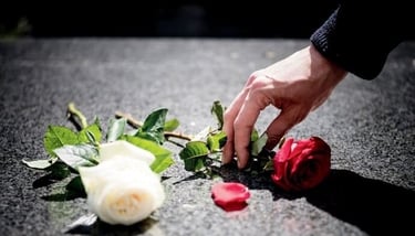 flores colocadas em sepultura como homenagem após cerimónia fúnebre organizada por funerária em Sint