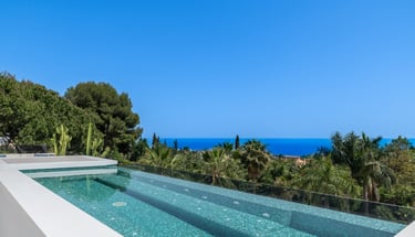 Rooftop pool, jacuzzi, and lounge area with panoramic sea views at Villa Serenity
