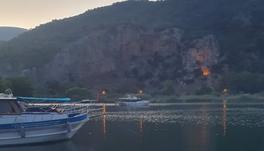 a boat is docked in a lake with a mountain in the background