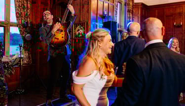 a man and woman playing guitar together in front of bride at wedding