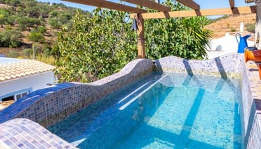 a pool with a wooden deck and a pool