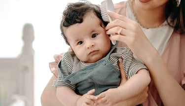 Mother holding baby near window – Fred Art Studio family session