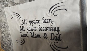 Close-up of custom embroidered label sewn into a handmade memory quilt