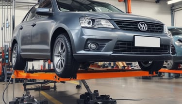 Several racing tires are placed on a concrete floor, with one large tire in the foreground. A person is kneeling and working on a tire, while another person stands nearby wearing green gloves. The background shows a garage environment with tools and equipment.