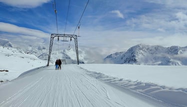 a person standing on a ski slope with a ski lift
