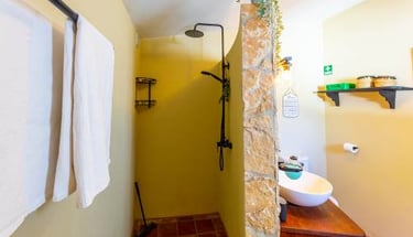 a bathroom with a stone shower and a sink