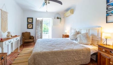a bedroom with a bed and a ceiling fan