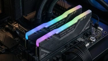 Two sticks of high-performance DDR5 RAM with glowing RGB lighting installed on a black motherboard.