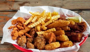 Captain’s Combo Platter Meal with fried fish, clams, oysters, shrimp, calamari, and crinkle‑cut fries from Captain’s Galley