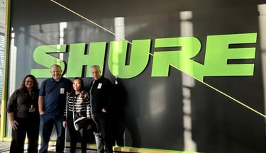 Michelle  Felix standing with SHURE Inc. team