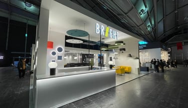 Modern exhibition booth with sleek white design and integrated lighting at trade show