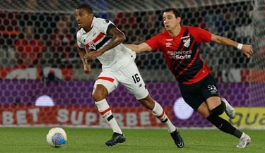 two men playing soccer on a field