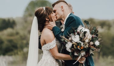 bride and groom share first kiss after ceremony, Kalispell mountains