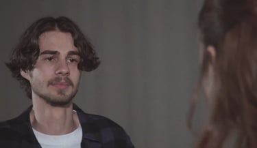 a man with a beard and a woman with a white shirt