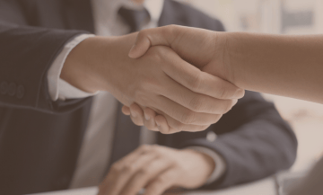 a man and woman shaking hands in a meeting