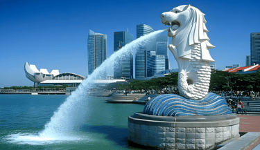 Iconic Merlion statue with water spewing, symbolizing Singapore's cultural heritage and modern sky