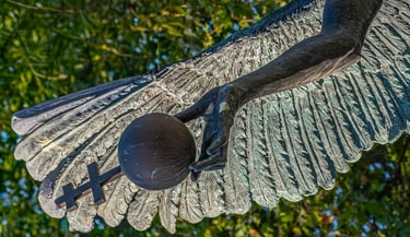Close-up of Archangel Gabriel’s bronze hand as the state orb slips from his grasp.