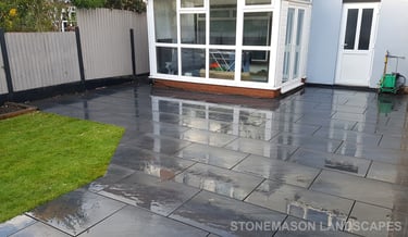 Grey sandstone circle paving slabs with charcoal edging