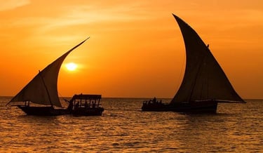 Romantic sunset views aboard a classic Zanzibar dhow cruise, with golden skies and calm waters.