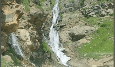 Water stream flowing down by a mountain