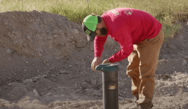 man working on well pump cover