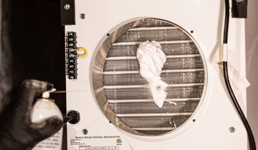 Clint Smith performing maintenance on a dehumidifier
