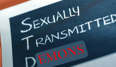 Close-up of text reading Sexually Transmitted Demons written in chalk on a blackboard.