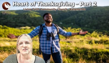 A man stands with arms wide in a field for the Heart of Thanksgiving sermon at Living Faith Community Church.