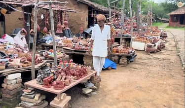 Local artisans displaying handmade terracotta handicrafts at Shilpgram, Udaipur.
