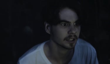 a man with a mustache and a white shirt